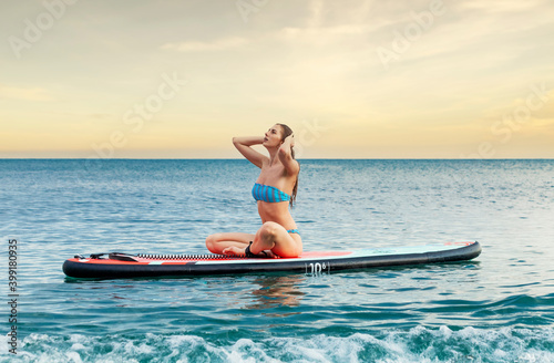 girl swims on a surfboard