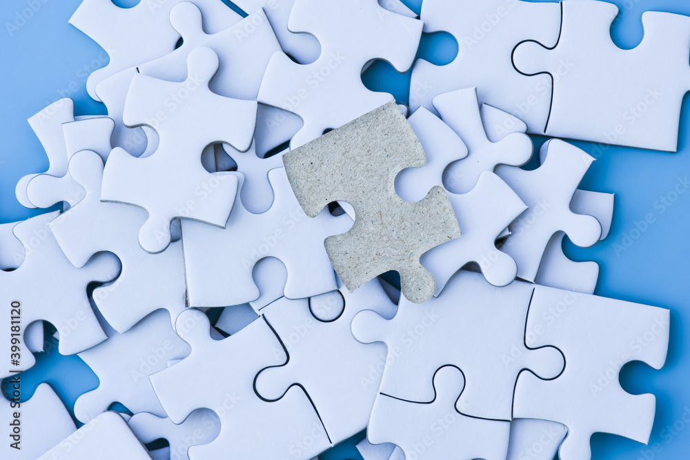 White jigsaw puzzle on blue background. White jigsaw puzzle on blue background.