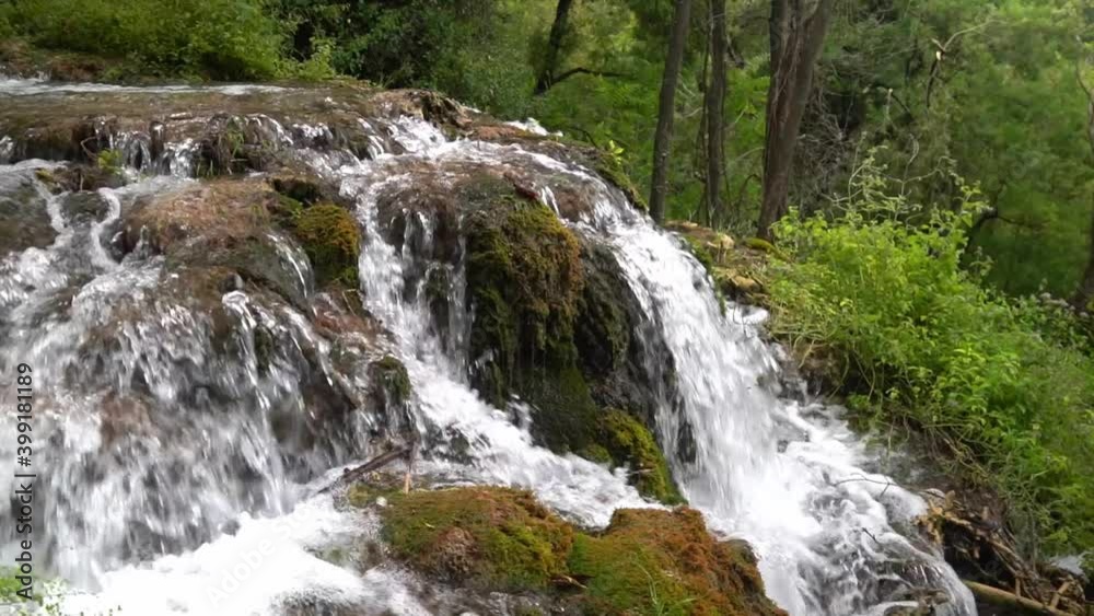 Water flowing over a rocky formation covered in moss at Krka National Park in Croatia at ¼ speed