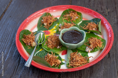 Royal leaf wrap appetizer is called Miang Kham which is a traditional snack from Thailand - selective focus