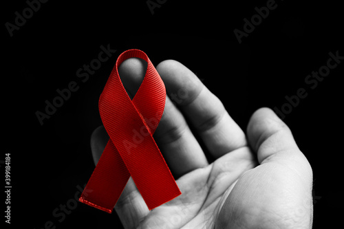 red AIDS ribbon on the hand