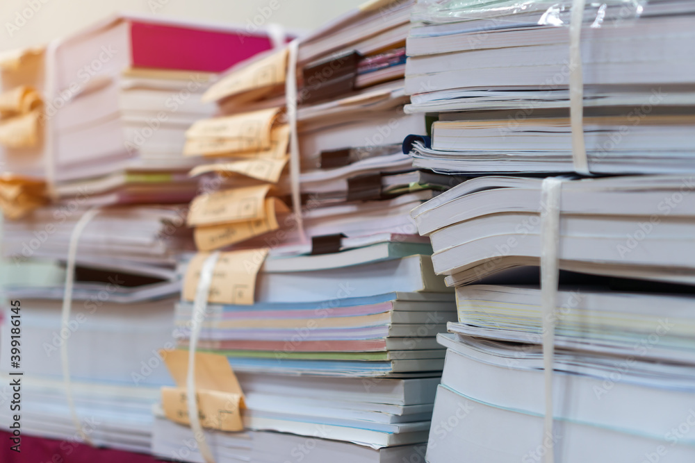 Fototapeta premium Pile of bunch education documents or books report teacher after approve and checking from admistrator, Annual Reports document for evaluation in student study in university office