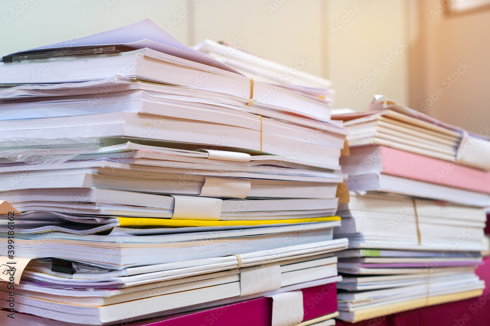 Pile of books and documents report papers waiting be managed on desk in busy office. Concept of workload in business finacial paperwork information planing Pile of books and documents report papers waiting be managed on desk in busy office. Concept of workload in business finacial paperwork information planing