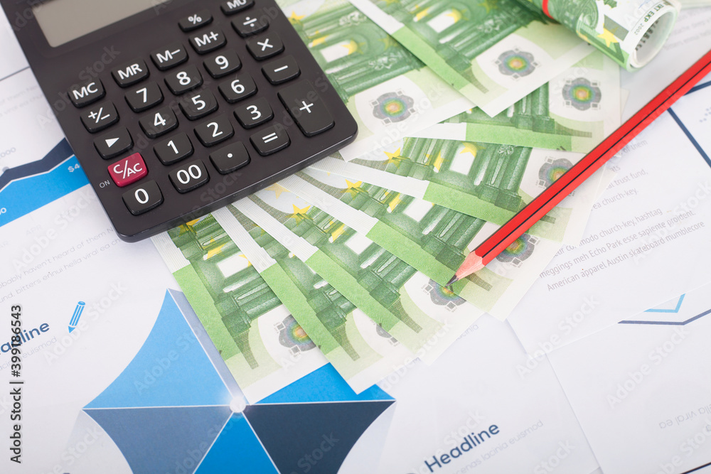 Euro currency and calculator and a pencil on chart materials Euro currency and calculator and a pencil on chart materials
