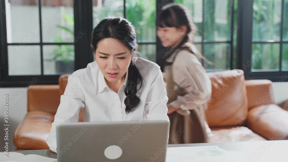 Asian businesswoman working at home with their children playing around Asian businesswoman working at home with their children playing around