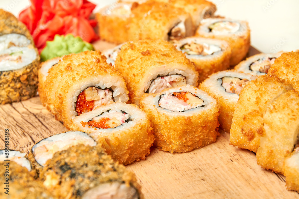 Set of various sushi rolls on a board. Close-up, selective focus Set of various sushi rolls on a board. Close-up, selective focus