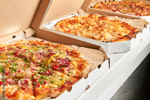 Pizza in open boxes prepared for delivery