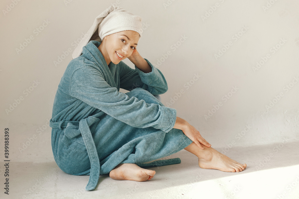 Girl in a studio. Lady in a blue bathrobe. Woman on a white background. Girl in a studio. Lady in a blue bathrobe. Woman on a white background.