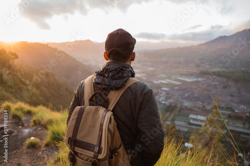 Portrait adventurous man with a backpack enjoying the mountain scenery