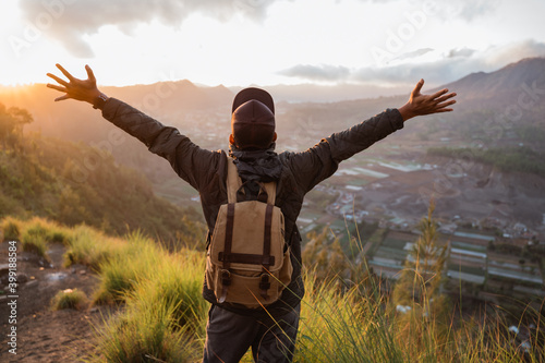 Portrait adventurous man with a backpack enjoying the mountain scenery photo