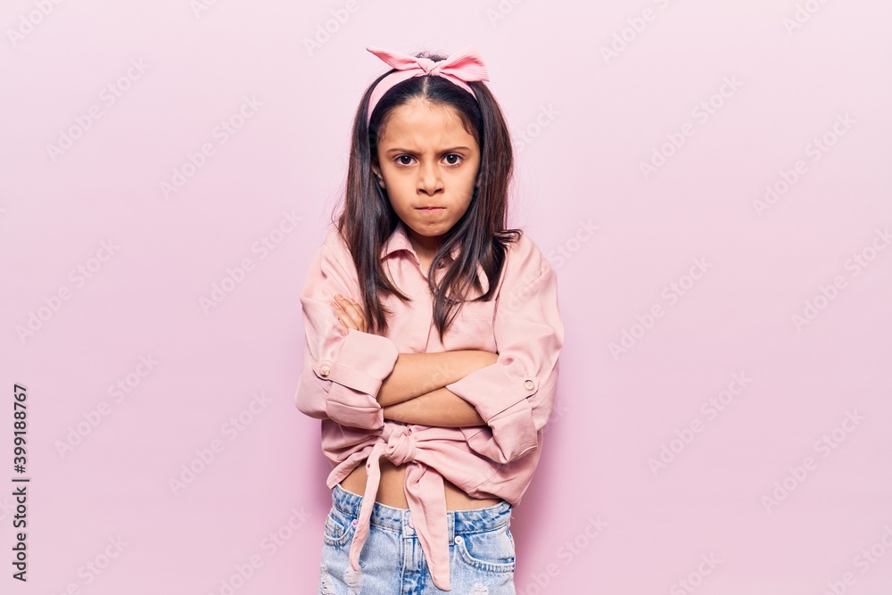 Beautiful child girl wearing casual clothes skeptic and nervous, disapproving expression on face with crossed arms. negative person. Beautiful child girl wearing casual clothes skeptic and nervous, disapproving expression on face with crossed arms. negative person.