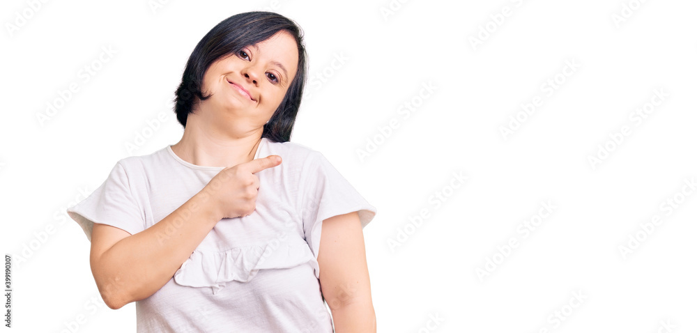 Brunette woman with down syndrome wearing casual white tshirt pointing with hand finger to the side showing advertisement, serious and calm face Brunette woman with down syndrome wearing casual white tshirt pointing with hand finger to the side showing advertisement, serious and calm face