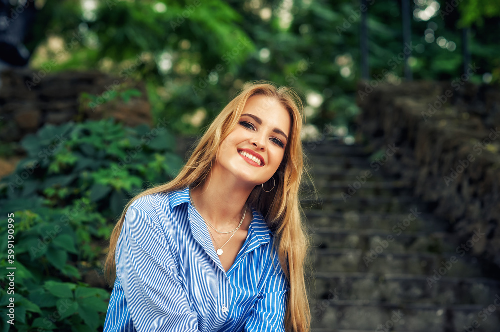Portrait of a young happy woman on the street of a European city