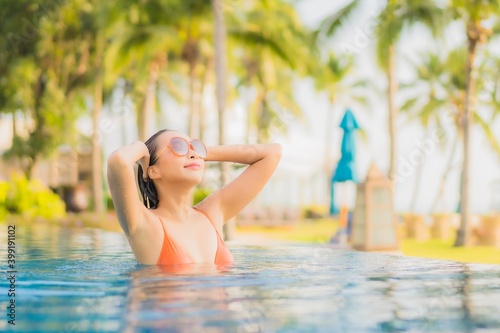 Portrait beautiful young asian woman relax smile leisure around outdoor swimming pool nearly sea beach ocean © siraphol