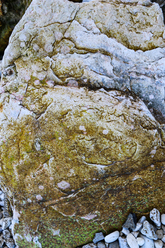 mountain textures of stones with interlayers of gypsum, colored quartz, clay, sand and other layers of various ores, with different textures, color and density, in gypsum ore quarry. photo