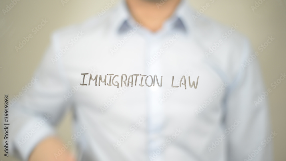 Immigration Law, man writing on transparent screen Immigration Law, man writing on transparent screen