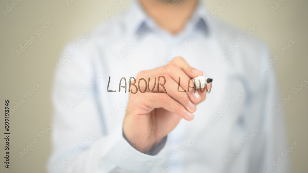 Labour Law, man writing on transparent screen Labour Law, man writing on transparent screen