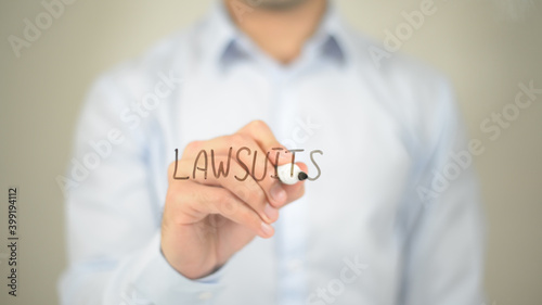 Law Suits, man writing on transparent screen photo