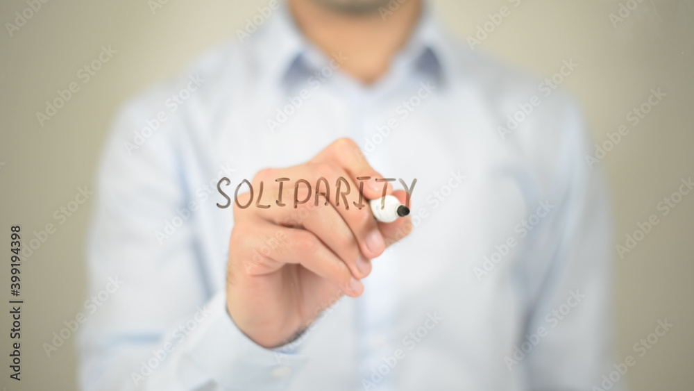 Solidarity , man writing on transparent screen Solidarity , man writing on transparent screen