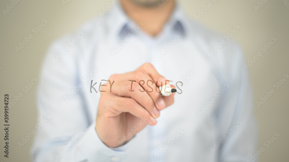 Key Issues , man writing on transparent screen Key Issues , man writing on transparent screen