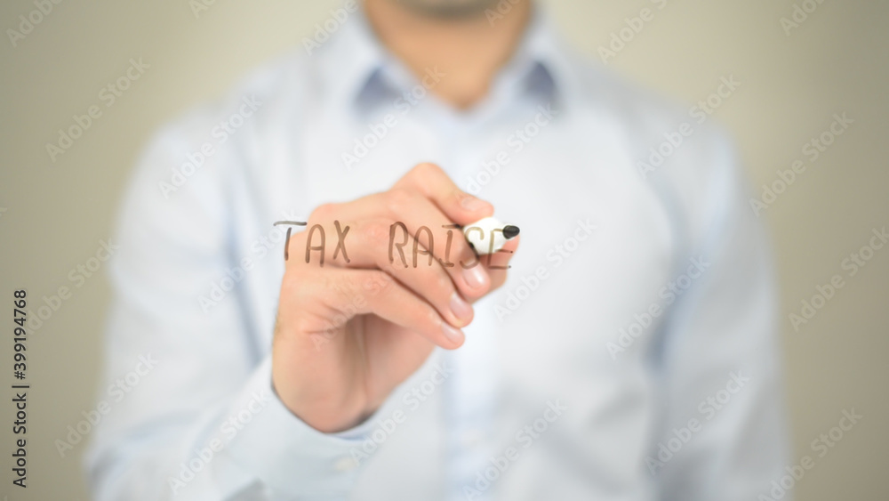 Tax Raise , man writing on transparent screen Tax Raise , man writing on transparent screen