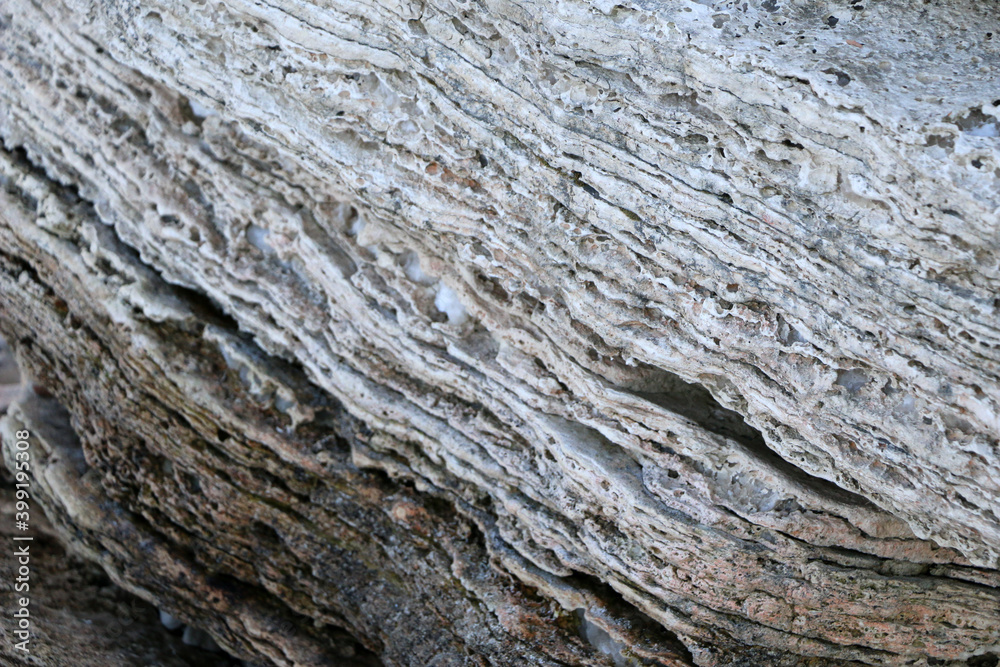 mountain textures of stones with interlayers of gypsum, colored quartz, clay, sand and other layers of various ores, with different textures, color and density, in gypsum ore quarry. mountain textures of stones with interlayers of gypsum, colored quartz, clay, sand and other layers of various ores, with different textures, color and density, in gypsum ore quarry.