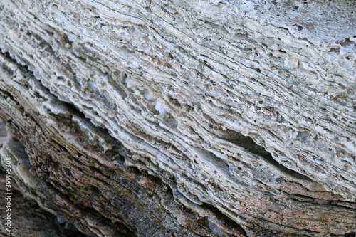 mountain textures of stones with interlayers of gypsum, colored quartz, clay, sand and other layers of various ores, with different textures, color and density, in gypsum ore quarry.