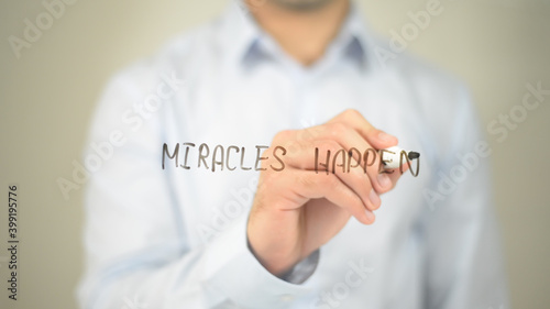 Miracels Happen , man writing on transparent screen