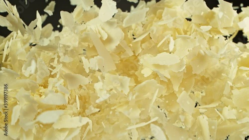 Super Slow Motion Shot of Flying Parmesan Shavings on Black Background at 1000 fps. photo