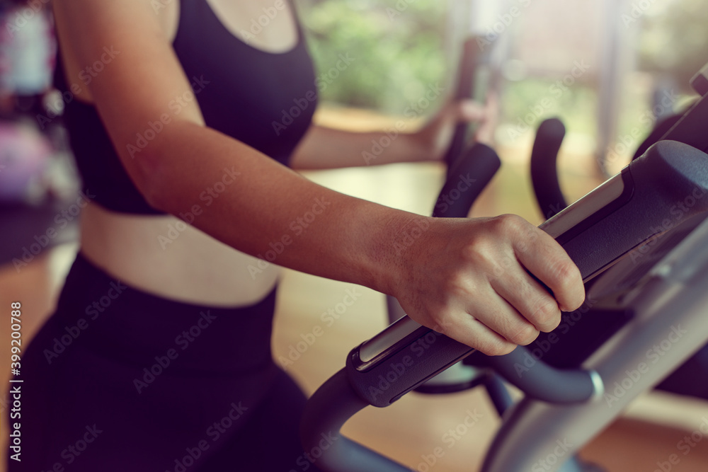 Close-up Sportwoman walking or running on treadmill equipment in fitness workout gym.Concept fitness ,workout, gym exercise ,lifestyle and healthy.