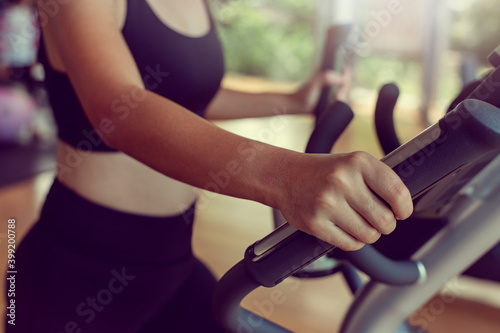 Close-up Sportwoman walking or running on treadmill equipment in fitness workout gym.Concept fitness ,workout, gym exercise ,lifestyle and healthy. © Thanumporn
