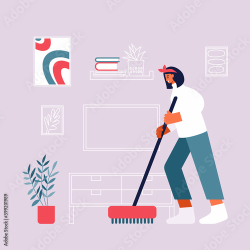Woman cleaning floor in living room at home