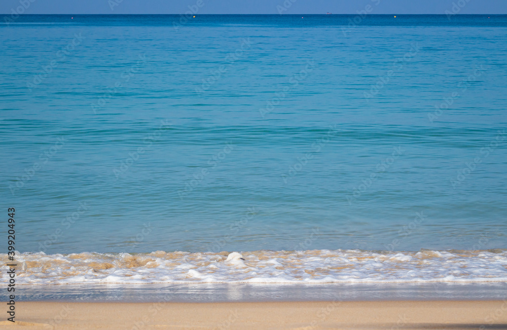 Breaking sea wave on a sandy beach background Breaking sea wave on a sandy beach background