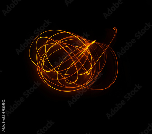 Obraz na płótnie Light wave trail path, vibrant neon gold color in abstract swirls on a black background w salonie