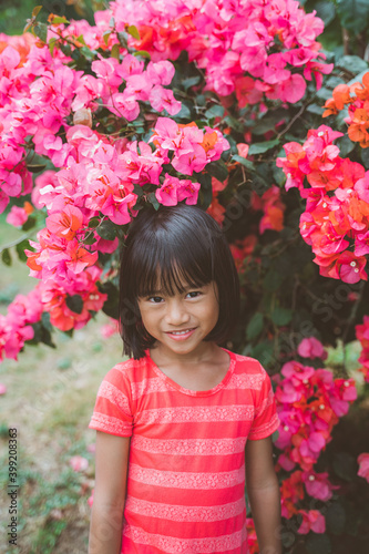 Portrait of little girl pictured on a colorful flower background