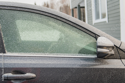 cropped photo of a car covered in frost  car care in winter