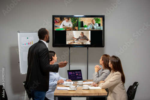 Leader. Young people talking, working in videoconference with colleagues, co-workers at office or living room. Online business, education during insulation, quarantine. Work, finance, tech concept.