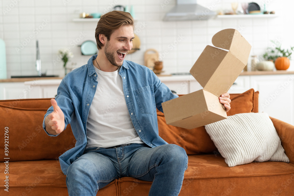 Happy man customer unpacking cardboard box receive open post mail delivery package