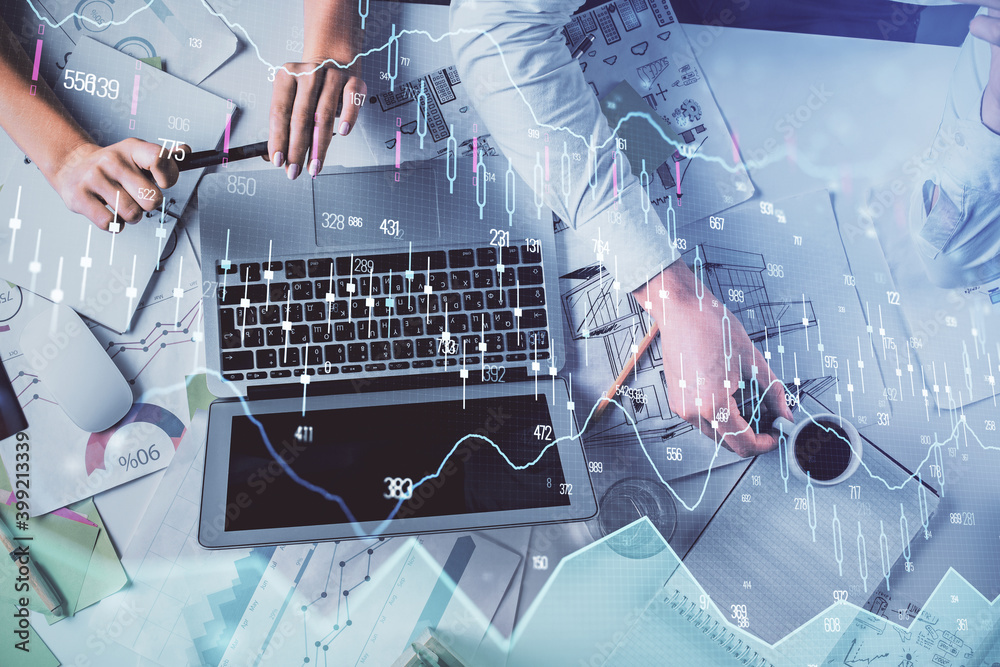 Double exposure of man and woman working together and financial graph hologram. Business concept. Computer background. Double exposure of man and woman working together and financial graph hologram. Business concept. Computer background.