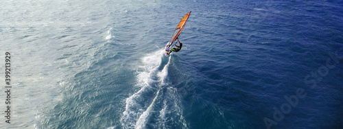 Canvas Print Aerial drone ultra wide top view photo of fit man practising wind surfing in Med