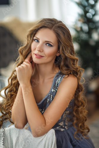 Close up portrait of young beautiful woman with gorgeous long hair at home.