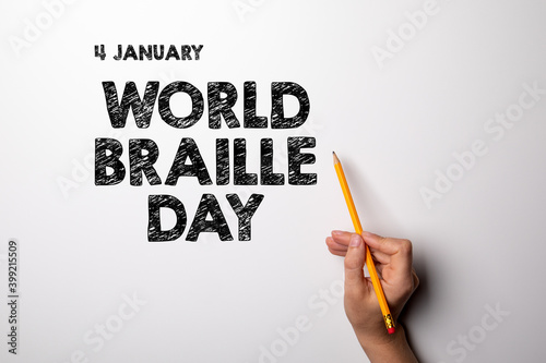 World Braille Day, 4 January. Woman's hand with a pencil photo