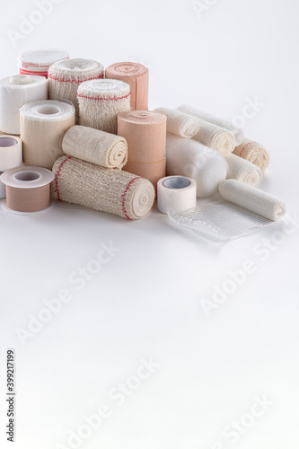 variety of bandages, gauze, cotton and Scotch tap on white background.