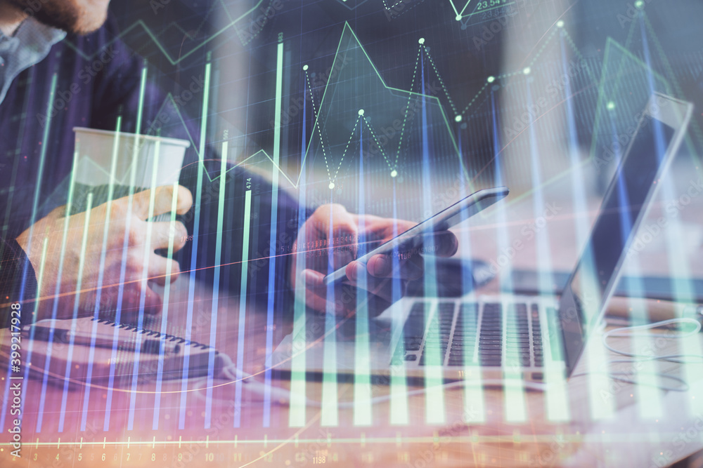 Double exposure of man's hands holding and using a phone and financial graph drawing. Analysis concept. Double exposure of man's hands holding and using a phone and financial graph drawing. Analysis concept.