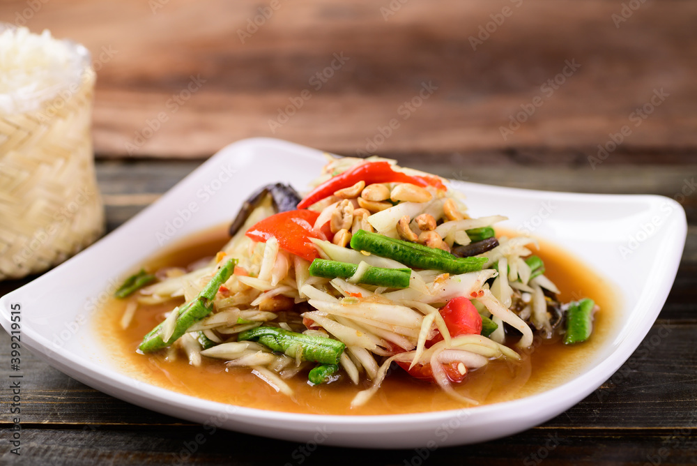 Thai food (Som Tum), Spicy green papaya salad eating with sticky rice Thai food (Som Tum), Spicy green papaya salad eating with sticky rice