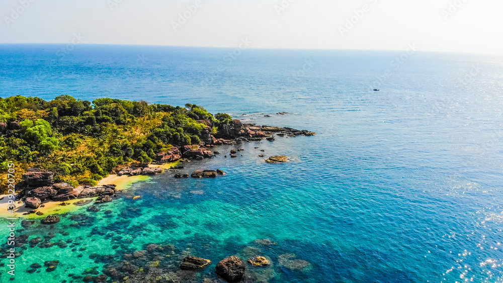 Aerial view of beautiful landscape, tourism boats, and people swimming on the sea and beach on May Rut island (a tranquil island with beautiful beach) in Phu Quoc, Kien Giang, Vietnam.