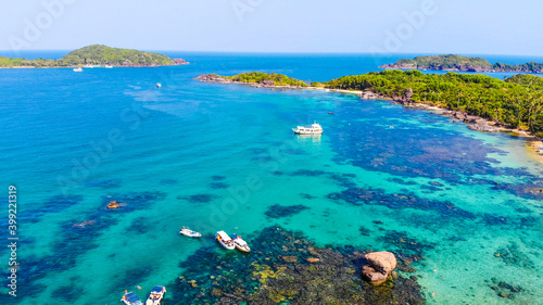 Fototapeta Naklejka Na Ścianę i Meble -  Aerial view of beautiful landscape, tourism boats, and people swimming on the sea and beach on May Rut island (a tranquil island with beautiful beach) in Phu Quoc, Kien Giang, Vietnam.