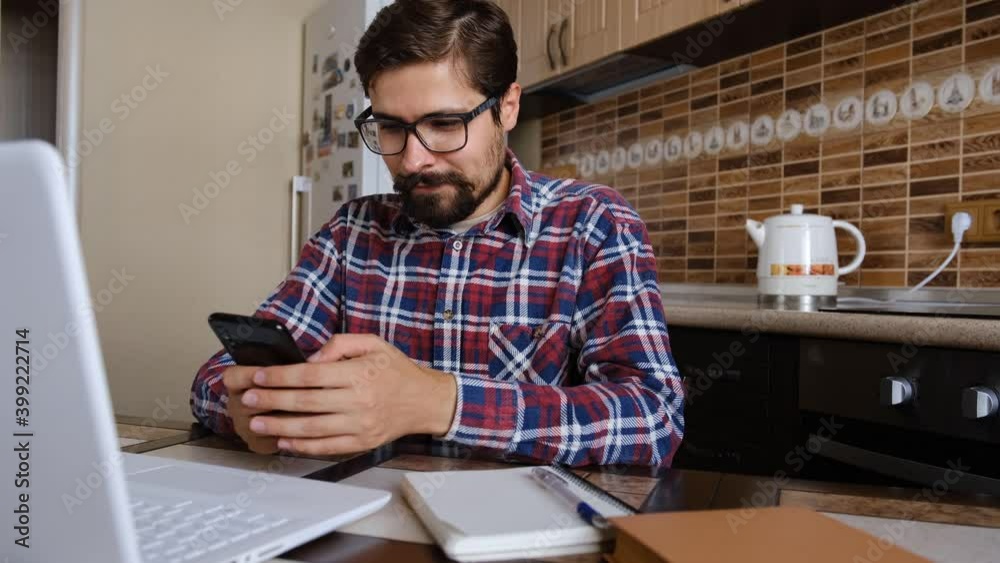 Male millennial professional holding modern smartphone texting message