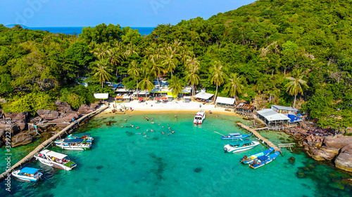 Aerial view of beautiful landscape, tourism boats, and people swimming on the sea and beach on May Rut island (a tranquil island with beautiful beach) in Phu Quoc, Kien Giang, Vietnam. © CravenA