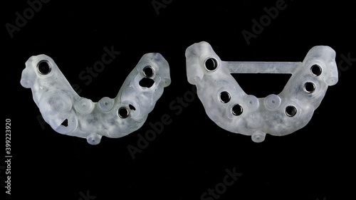 excellent composition of surgical dental templates with titanium sleeves, top view on a black background